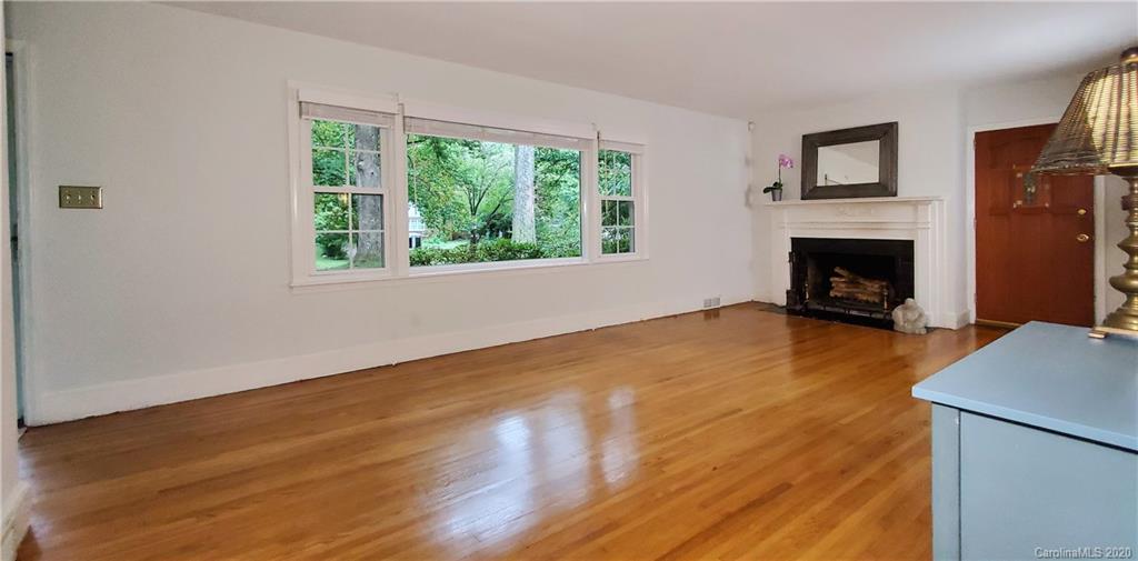 2221 Arnold Drive Charlotte, NC 28205 - Photo 14 of 23 a view of empty room with wooden floor and fireplace