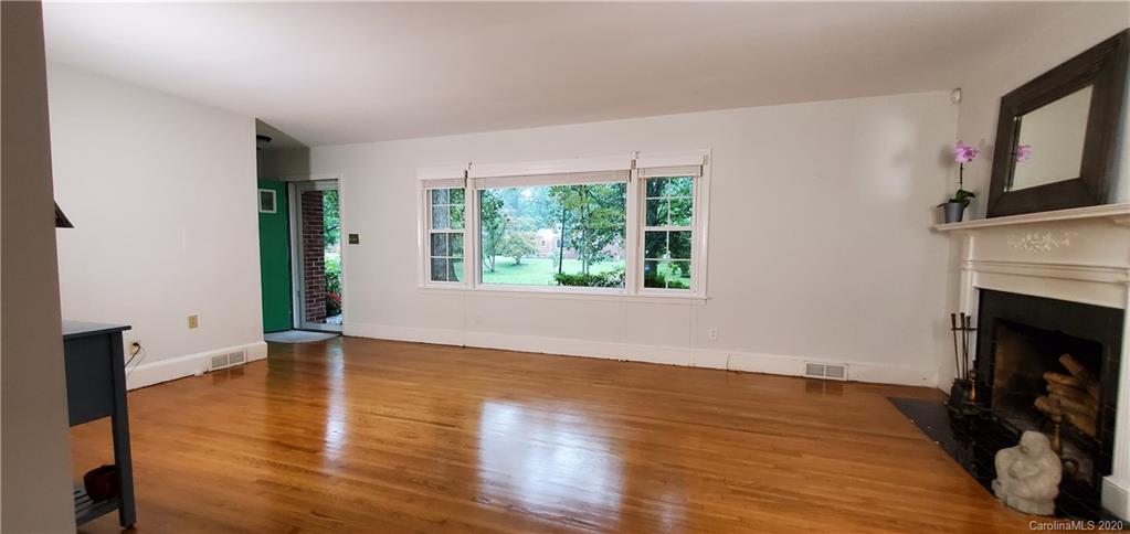 2221 Arnold Drive Charlotte, NC 28205 - Photo 16 of 23 a view of an empty room with wooden floor and a window