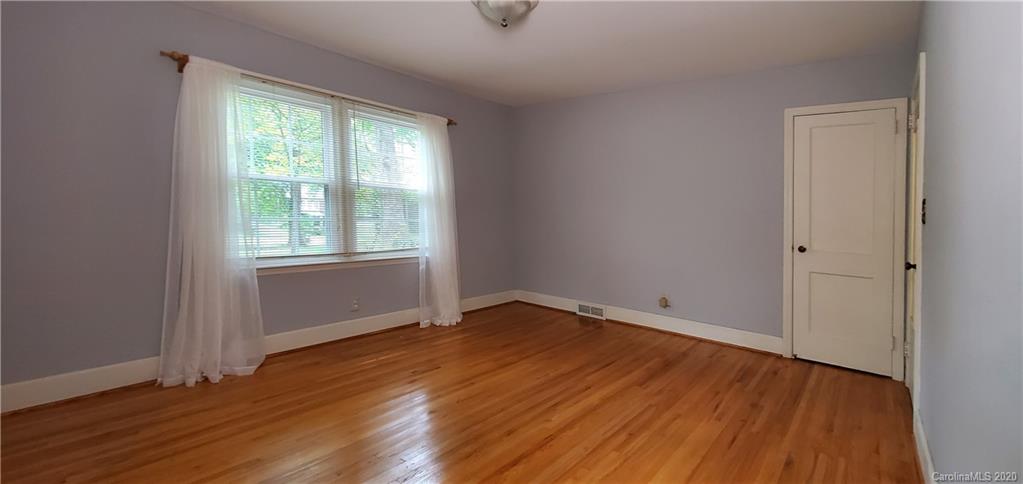 2221 Arnold Drive Charlotte, NC 28205 - Photo 19 of 23 an empty room with wooden floor and windows