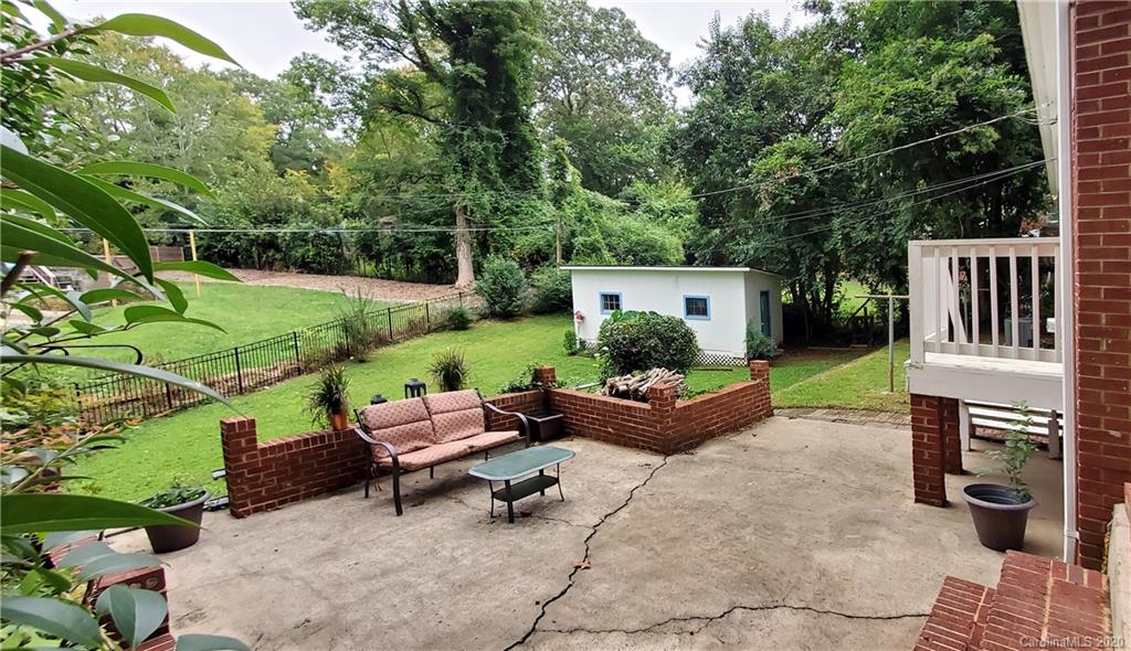 2221 Arnold Drive Charlotte, NC 28205 - Photo 3 of 23 a view of a backyard with couches plants and large trees