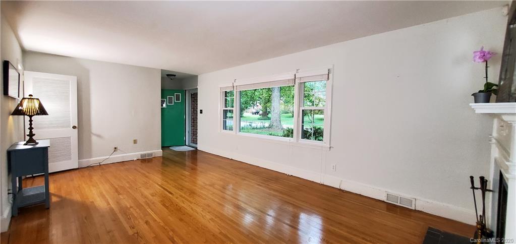 2221 Arnold Drive Charlotte, NC 28205 - Photo 6 of 23 a view of an empty room with wooden floor and a window