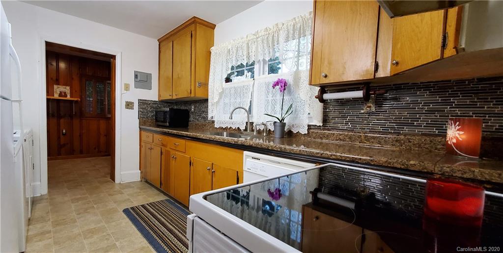 2221 Arnold Drive Charlotte, NC 28205 - Photo 7 of 23 a kitchen with stainless steel appliances granite countertop a sink and cabinets