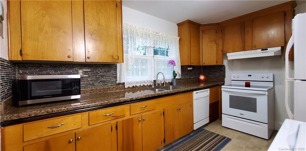 2221 Arnold Drive Charlotte, NC 28205 - Photo 8 of 23 a kitchen with granite countertop a sink a stove and cabinets