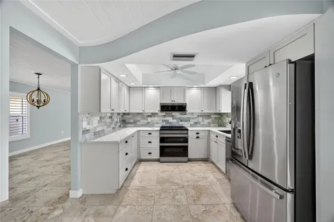 a kitchen with a refrigerator sink and stove