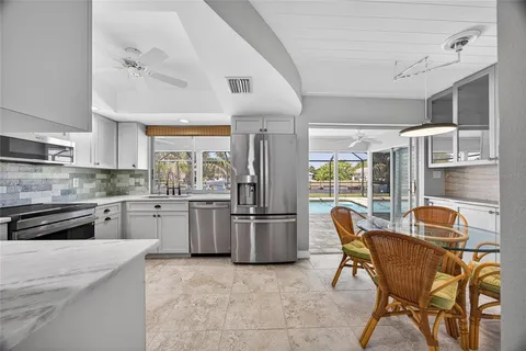 a kitchen with refrigerator cabinets and stove top oven