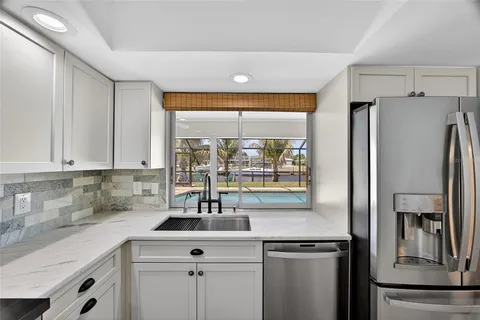 a kitchen with stainless steel appliances a sink stove and refrigerator