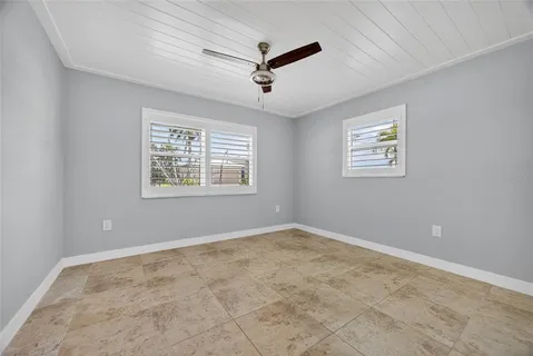 a view of a ceiling fan and window in a room