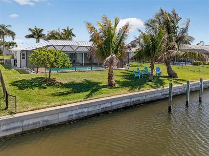 a view of a lake with a garden and swimming pool