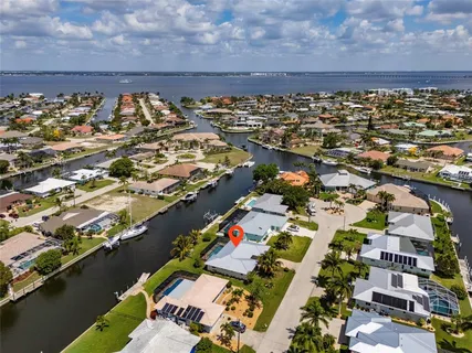 an aerial view of a house with a lake view