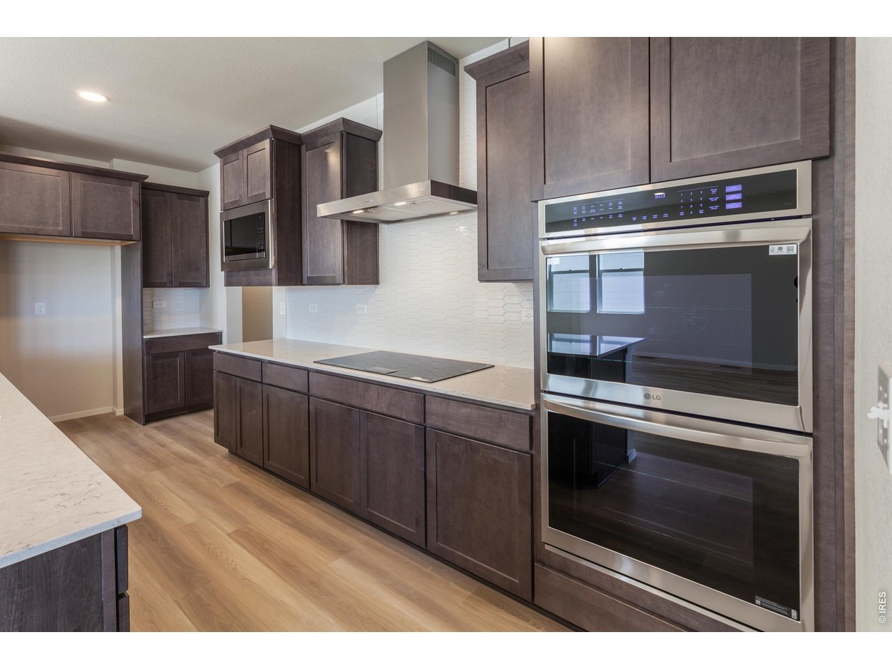 792 Chatter Road Windsor, CO 80550 - Photo 19 of 49 a kitchen with stainless steel appliances wooden cabinets and stove