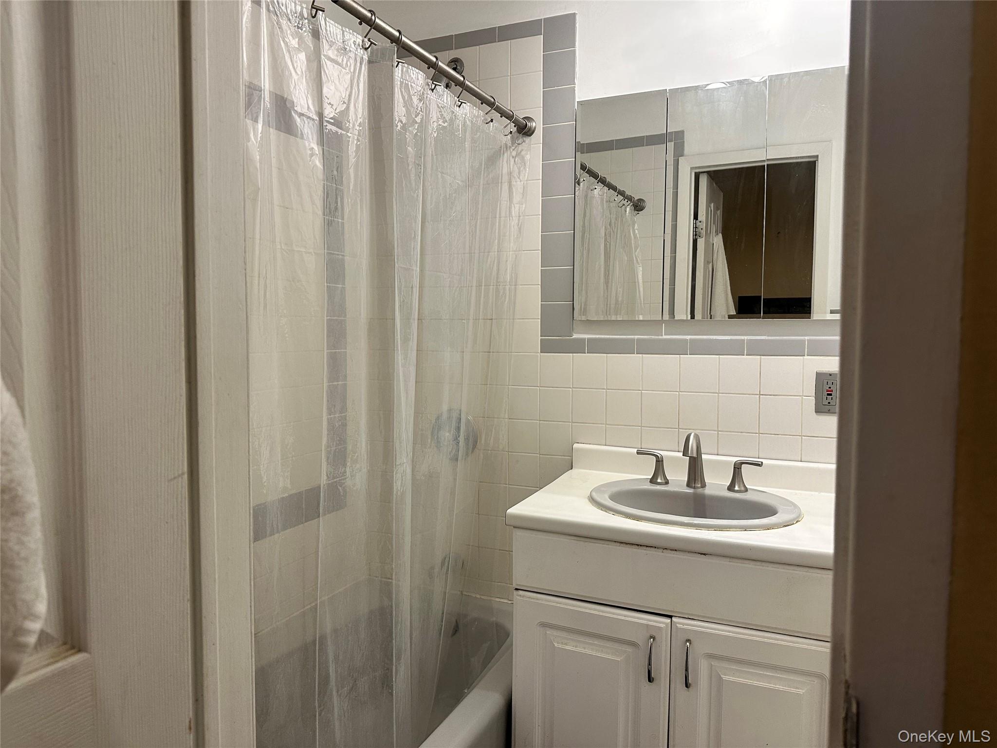 2201 Palmer Avenue, Unit 2F New Rochelle, NY 10801 - Photo 5 of 16 a bathroom with a sink and mirror