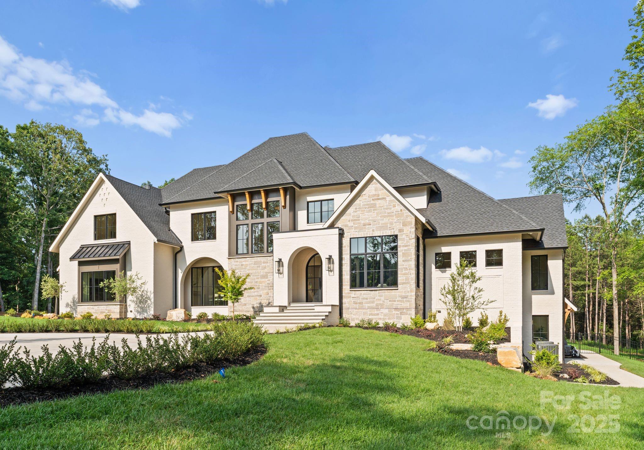15037 June Washam Road Davidson, NC 28036 - Photo 11 of 48 a front view of a house with a garden