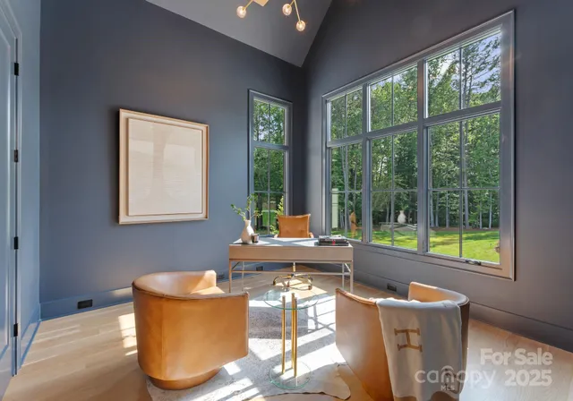 a living room with a large window and swimming pool