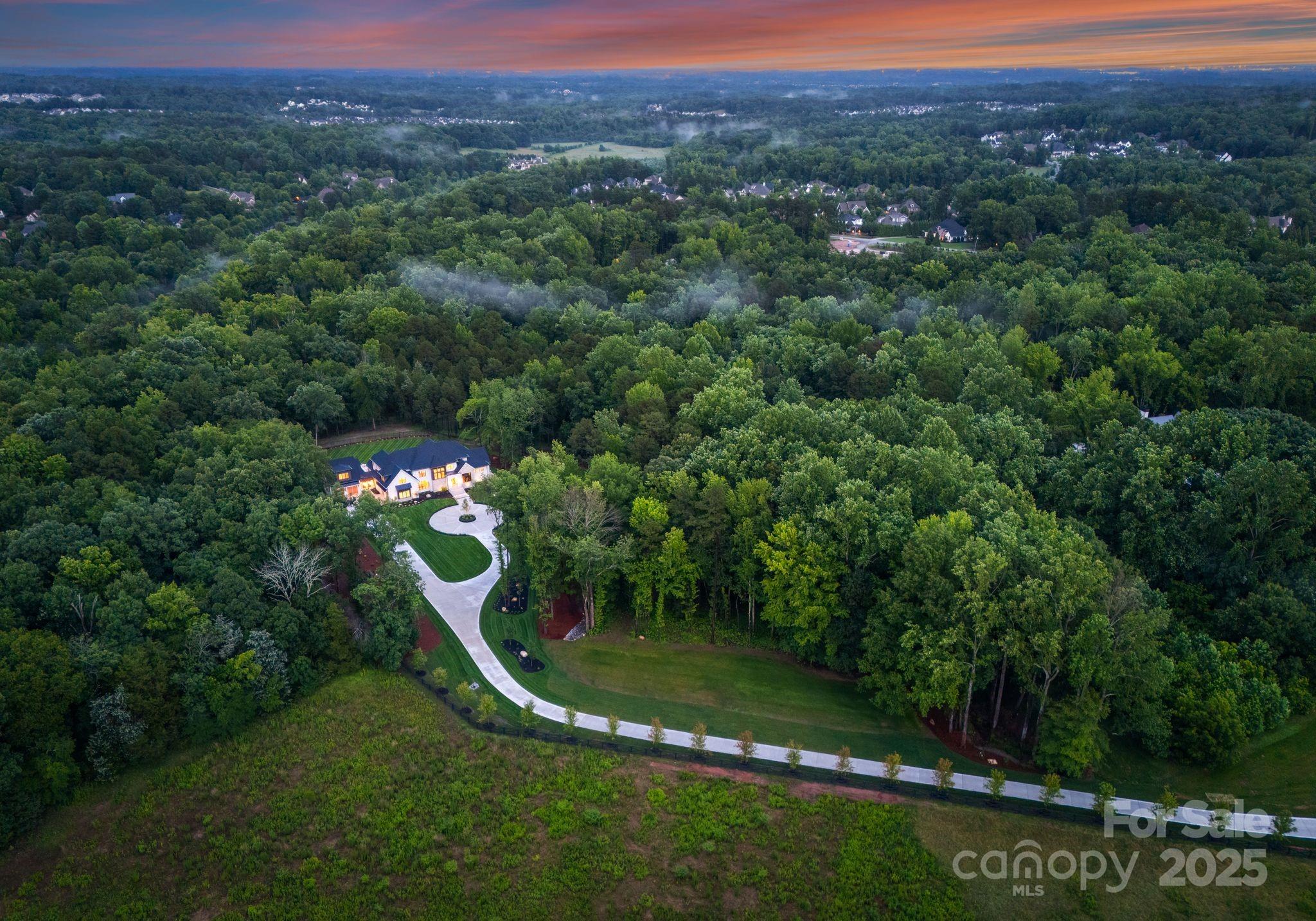 15037 June Washam Road Davidson, NC 28036 - Photo 2 of 48 a view of a garden with a building in the background