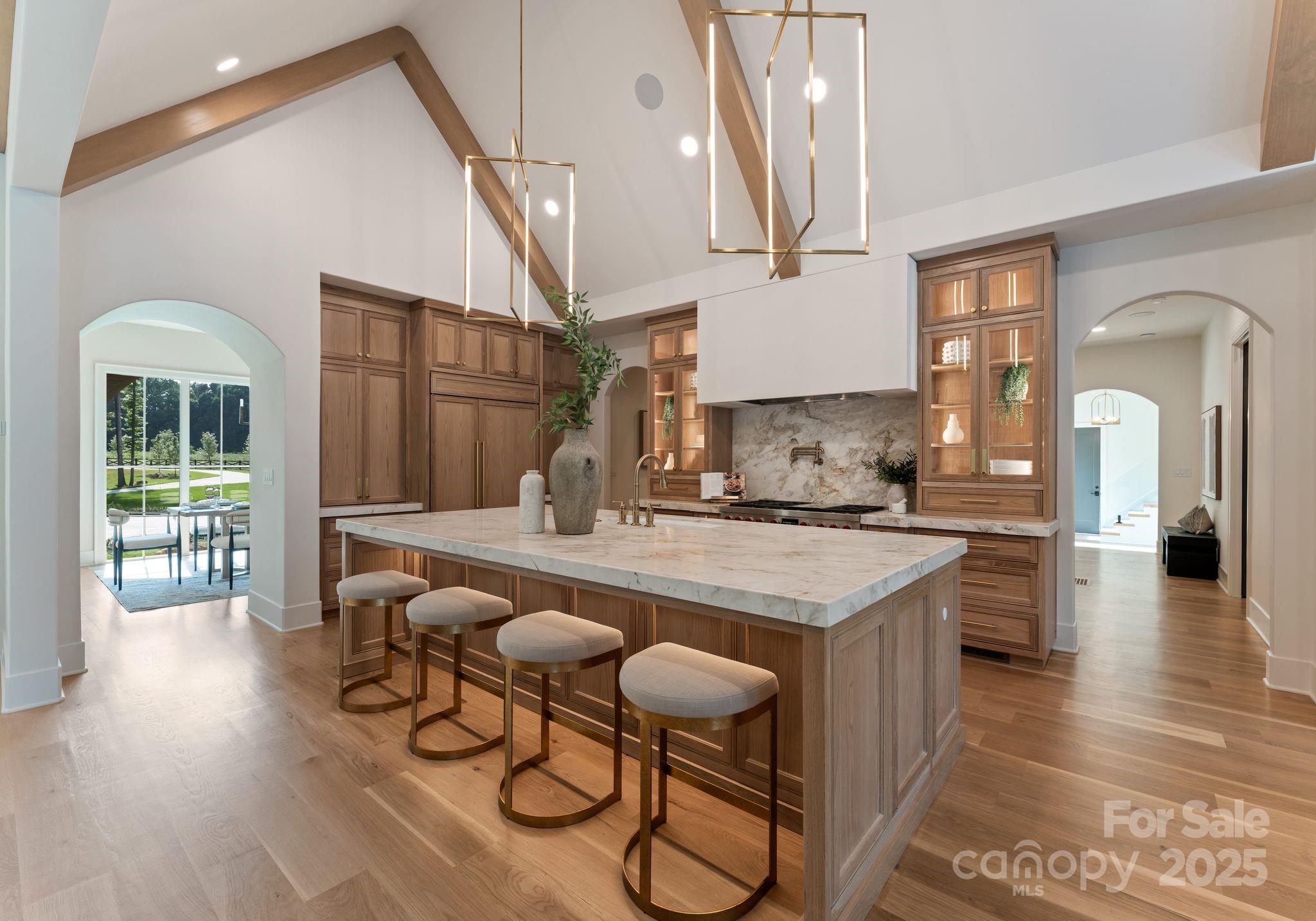 15037 June Washam Road Davidson, NC 28036 - Photo 21 of 48 a kitchen with a table chairs and entryway