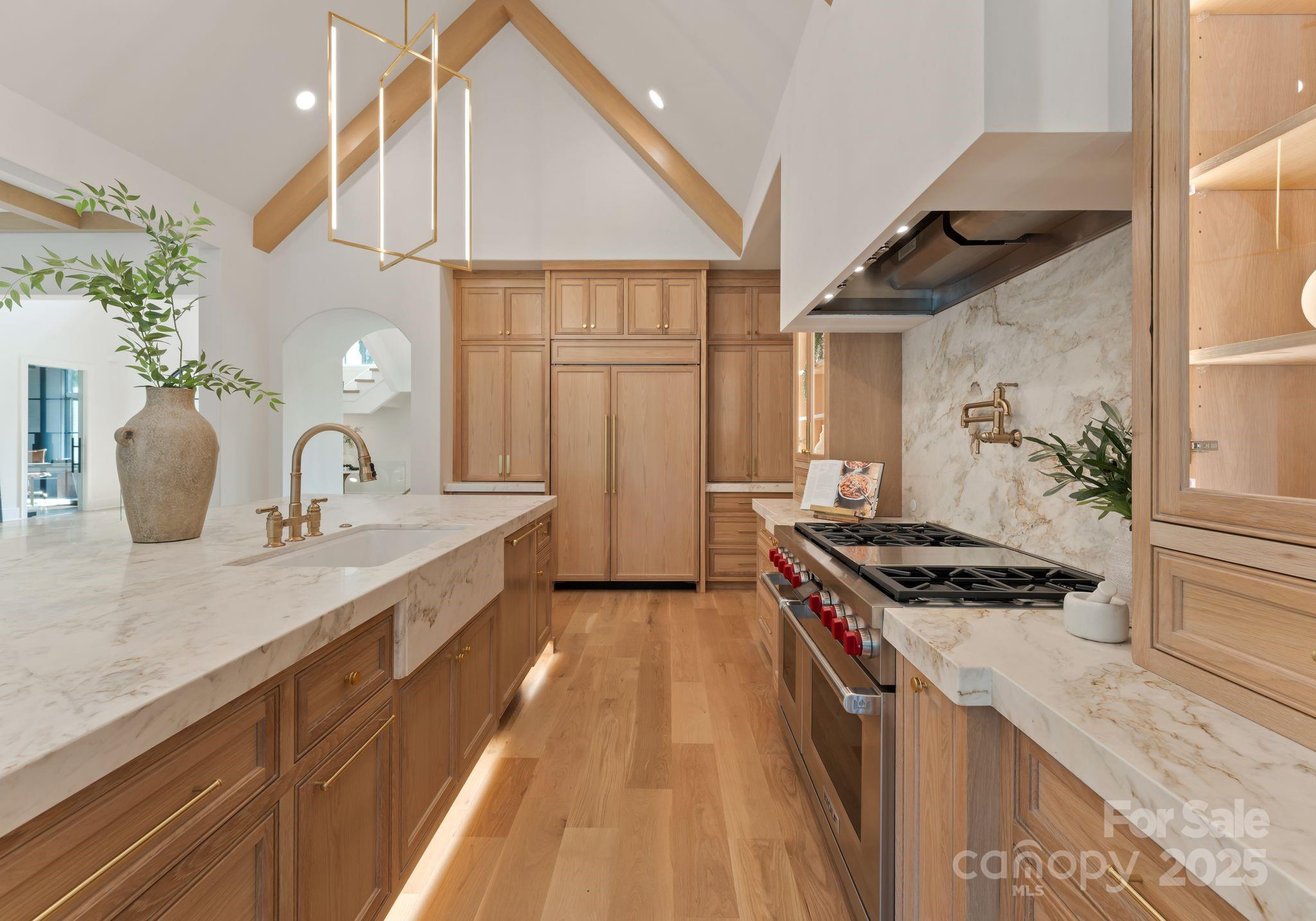15037 June Washam Road Davidson, NC 28036 - Photo 22 of 48 a kitchen with granite countertop a sink stove and cabinets