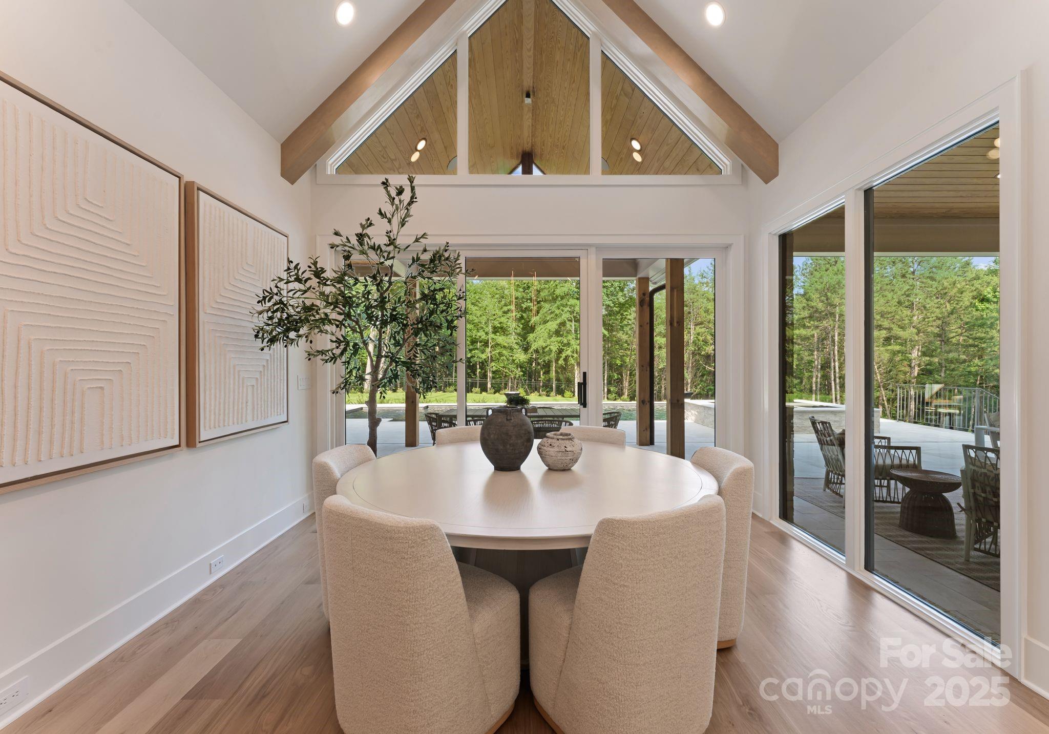 15037 June Washam Road Davidson, NC 28036 - Photo 24 of 48 a view of a dining room with furniture window and wooden floor