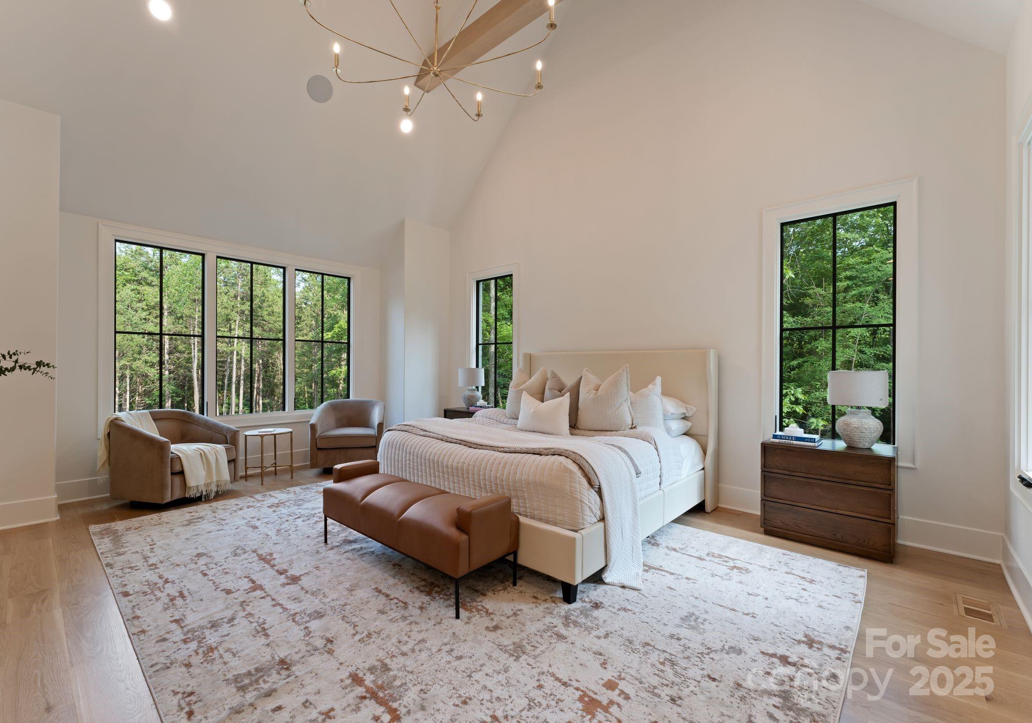 15037 June Washam Road Davidson, NC 28036 - Photo 26 of 48 a bedroom with a large bed couch and a window