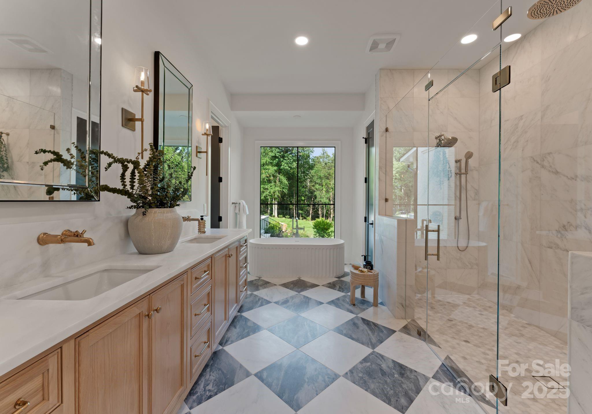 15037 June Washam Road Davidson, NC 28036 - Photo 27 of 48 a bathroom with a double vanity sink mirror and shower