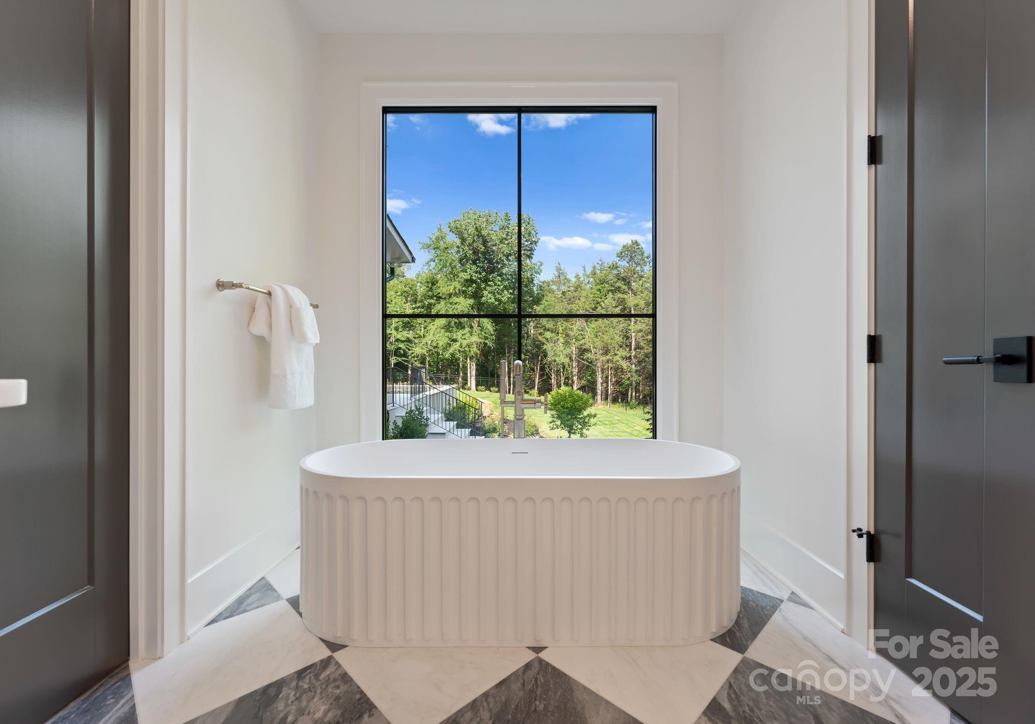 15037 June Washam Road Davidson, NC 28036 - Photo 30 of 48 a room with a table and a potted plant