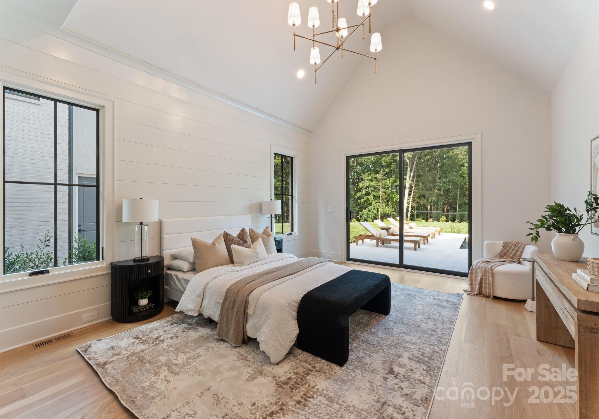 15037 June Washam Road Davidson, NC 28036 - Photo 33 of 48 a bedroom with a large bed and a large window