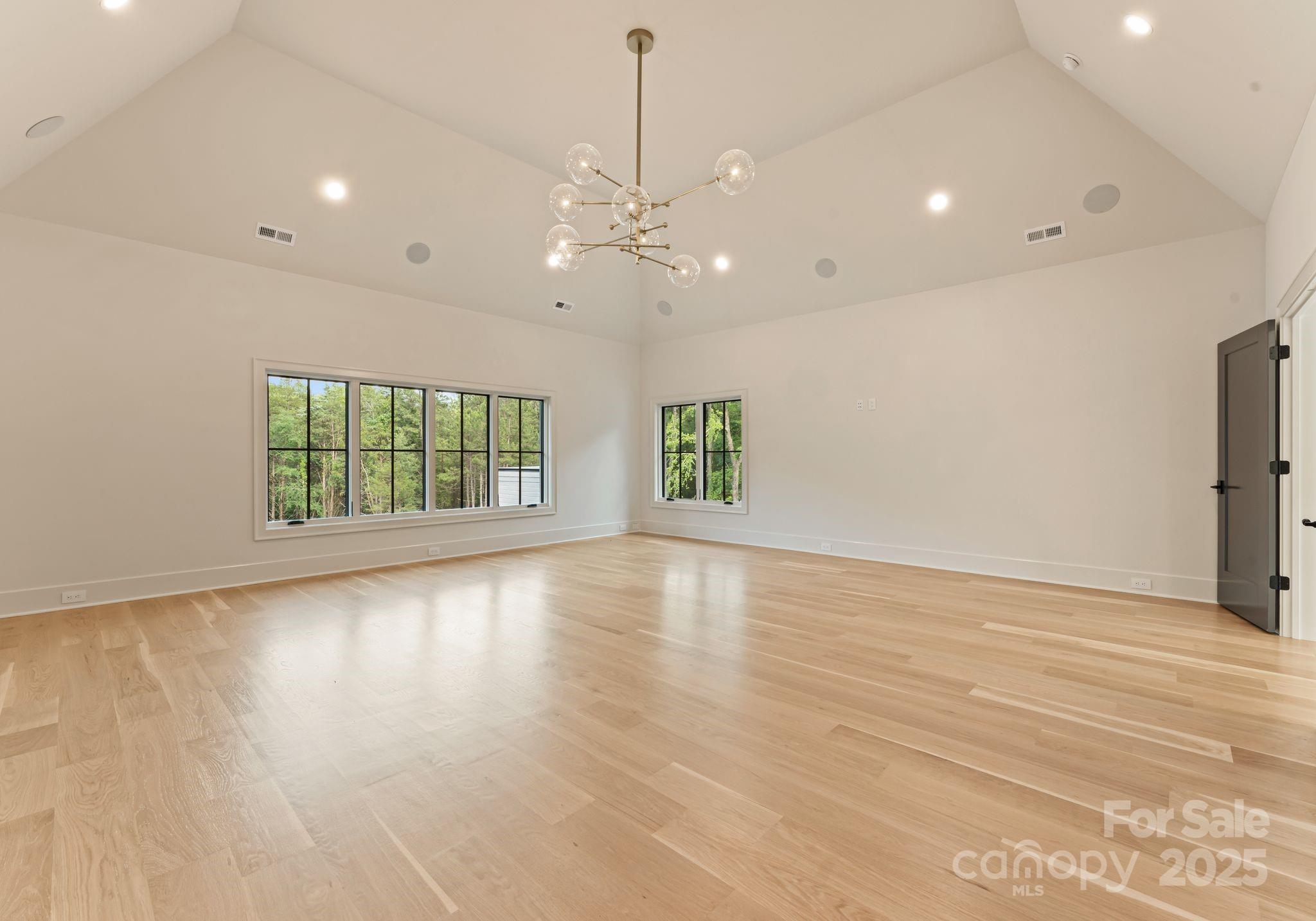 15037 June Washam Road Davidson, NC 28036 - Photo 39 of 48 an empty room with wooden floor and windows