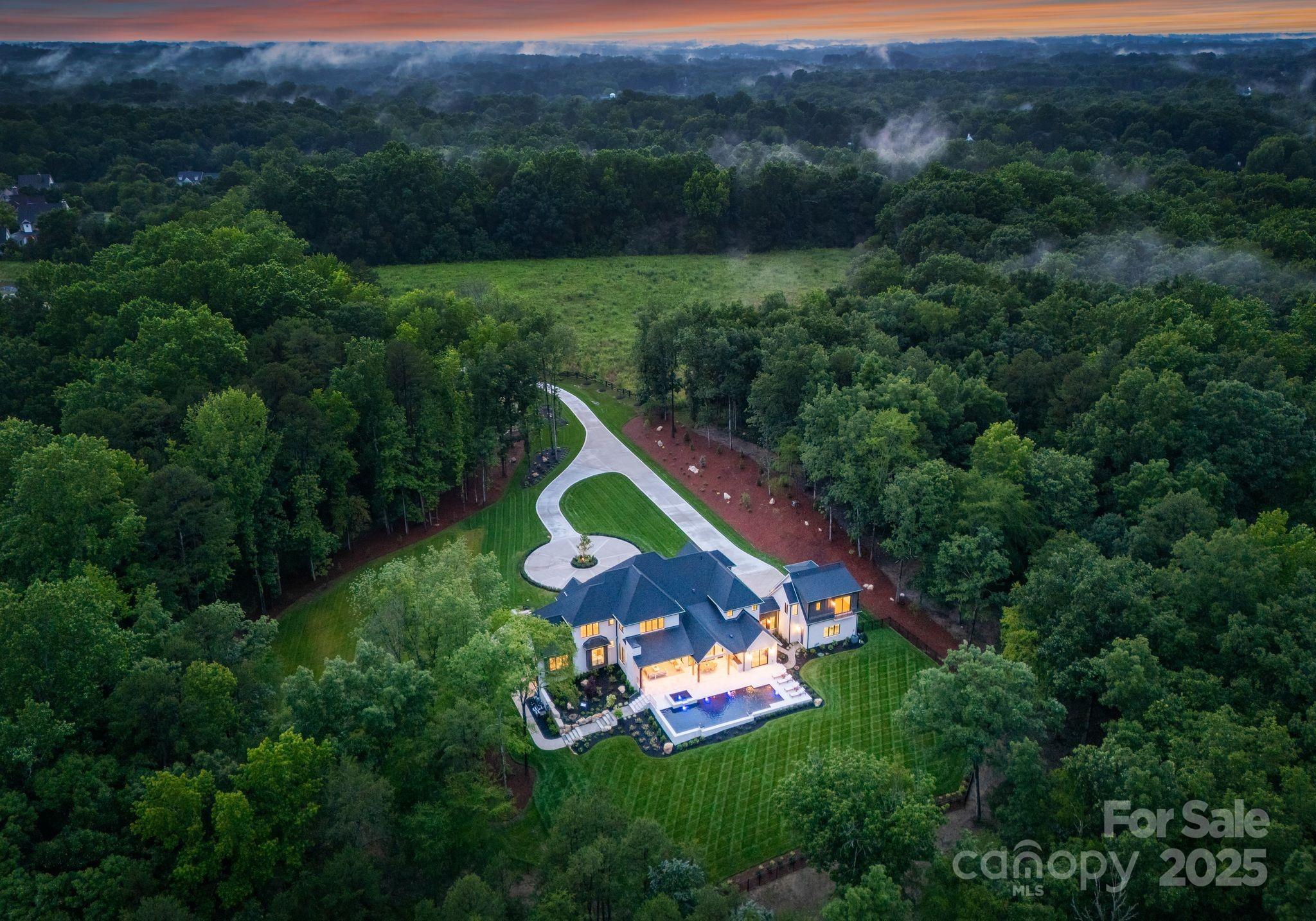 15037 June Washam Road Davidson, NC 28036 - Photo 4 of 48 an aerial view of a house with a garden