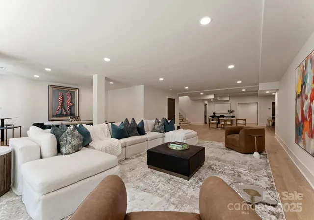 a living room with furniture and a view of kitchen