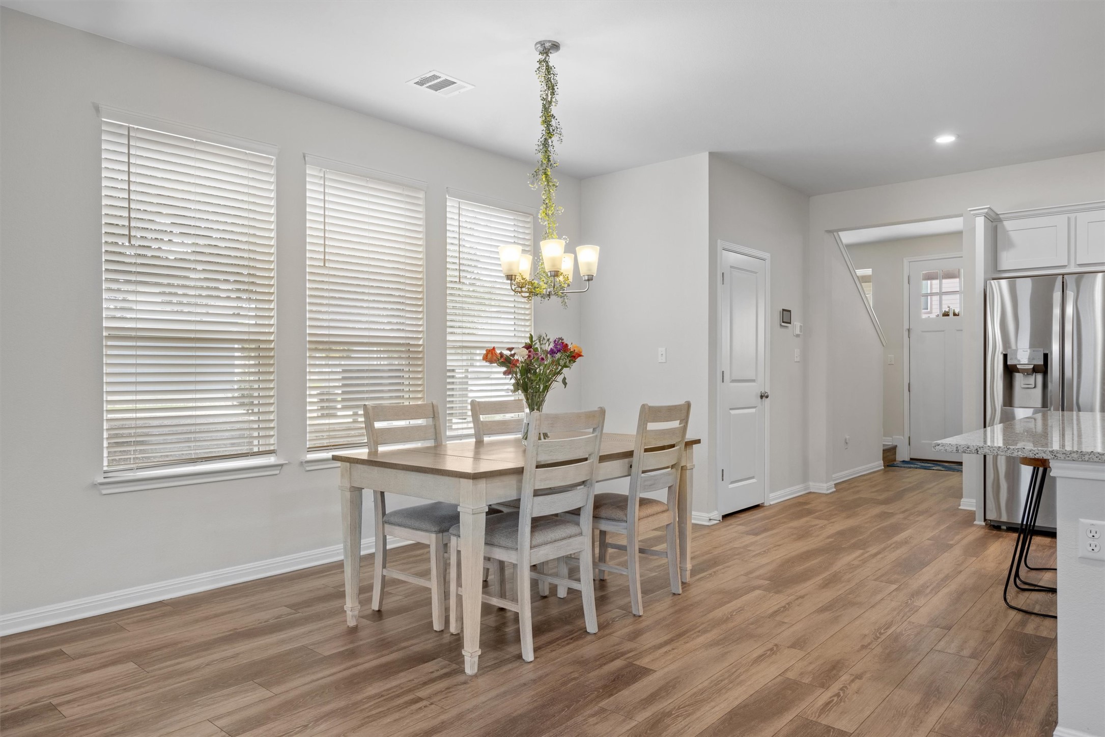 313 Toddy Way Leander, TX 78641 - Photo 11 of 40 a dining room with furniture window wooden floor and a chandelier