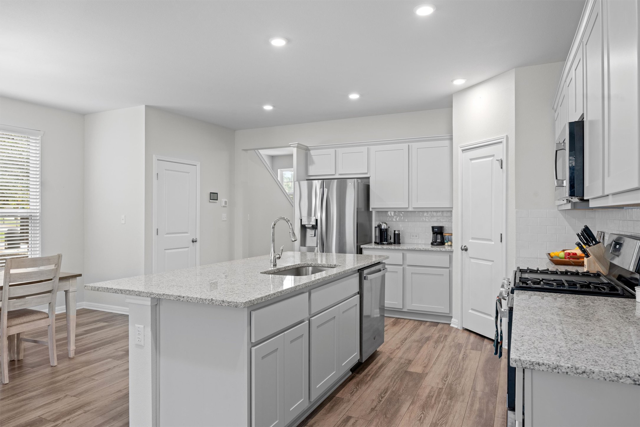 313 Toddy Way Leander, TX 78641 - Photo 13 of 40 a kitchen with stainless steel appliances granite countertop a sink stove and refrigerator