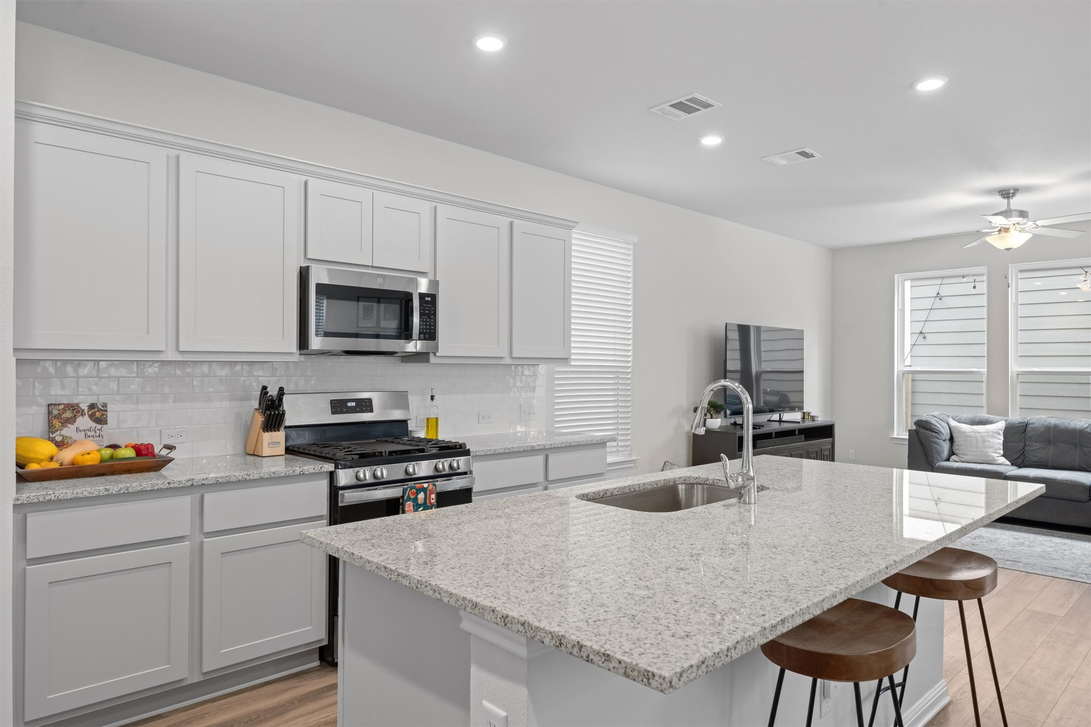 313 Toddy Way Leander, TX 78641 - Photo 40 of 40 a kitchen with sink a microwave a stove and cabinets