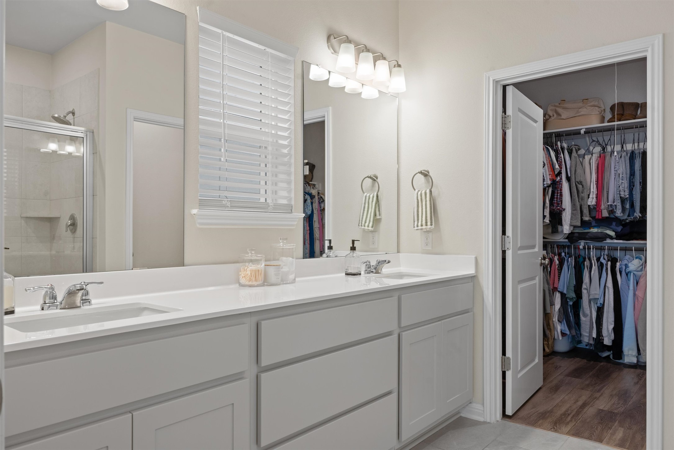 313 Toddy Way Leander, TX 78641 - Photo 19 of 40 a bathroom with a double vanity sink a and a mirror