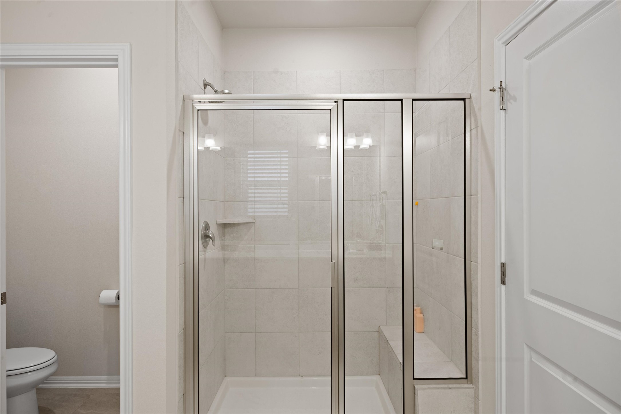 313 Toddy Way Leander, TX 78641 - Photo 20 of 40 a bathroom with a glass shower door