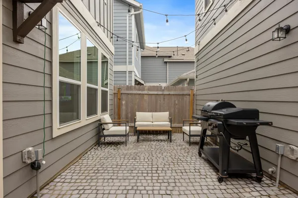 a view of a patio with table and chairs and wooden floor
