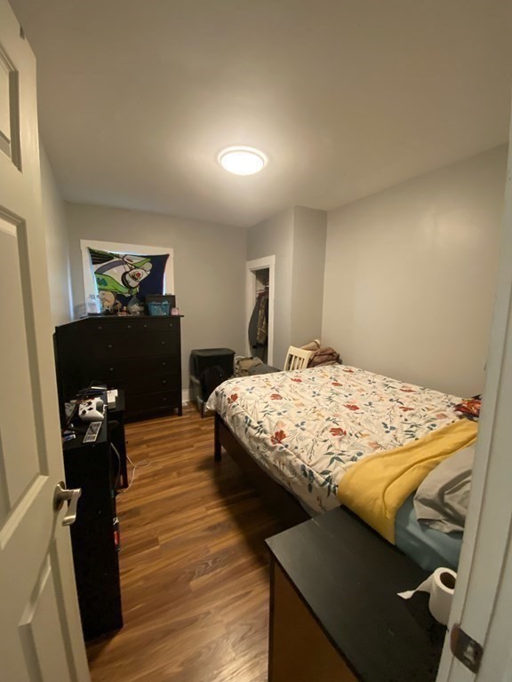 218 Vernon Street Worcester, MA 01607 - Photo 11 of 17 a bedroom with a bed and wooden floor