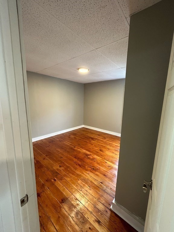 218 Vernon Street Worcester, MA 01607 - Photo 16 of 17 an empty room with wooden floor
