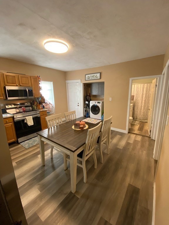 218 Vernon Street Worcester, MA 01607 - Photo 3 of 17 a dining room with a table chairs and a kitchen view