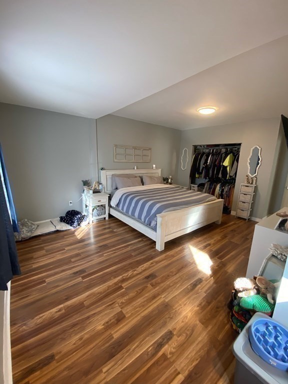 218 Vernon Street Worcester, MA 01607 - Photo 9 of 17 a bedroom with double bed and a wooden floor