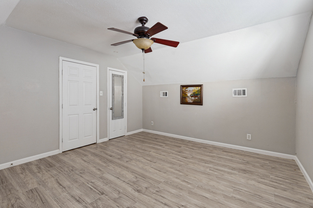 4709 Baton Rouge Street Houston, TX 77028 - Photo 4 of 16 Smooth wood-look flooring and angled ceilings define this versatile upper-level space.