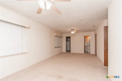 a view of empty room with a ceiling fan