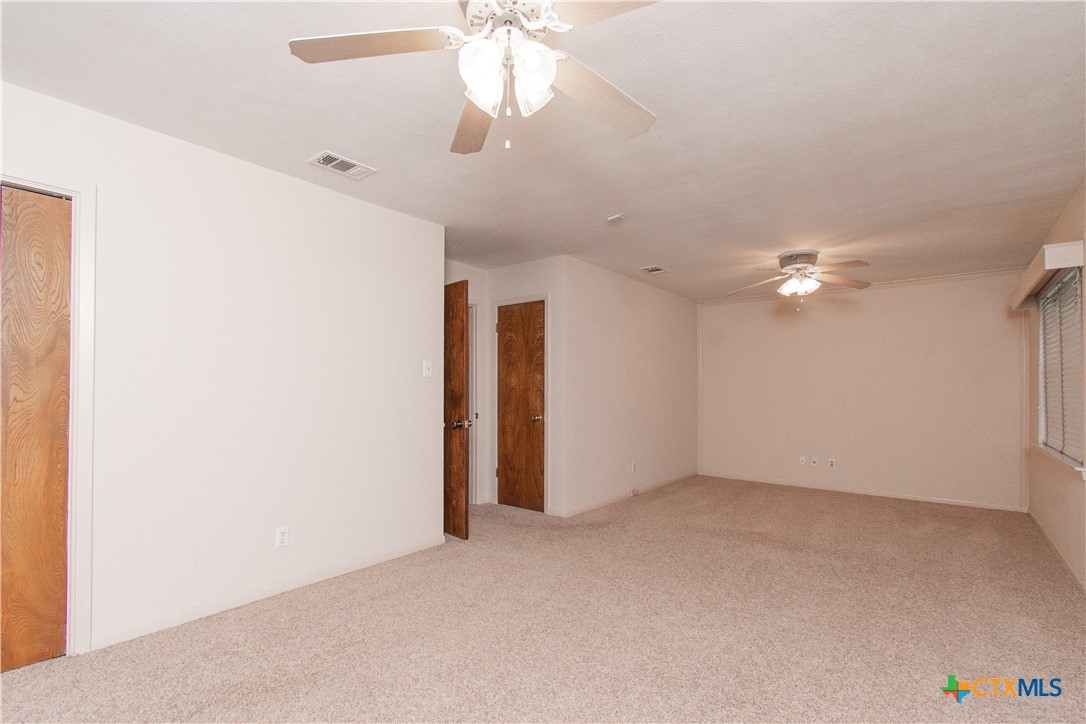 1 Timberline Drive Belton, TX 76513 - Photo 17 of 46 an empty room with a ceiling fan and a window