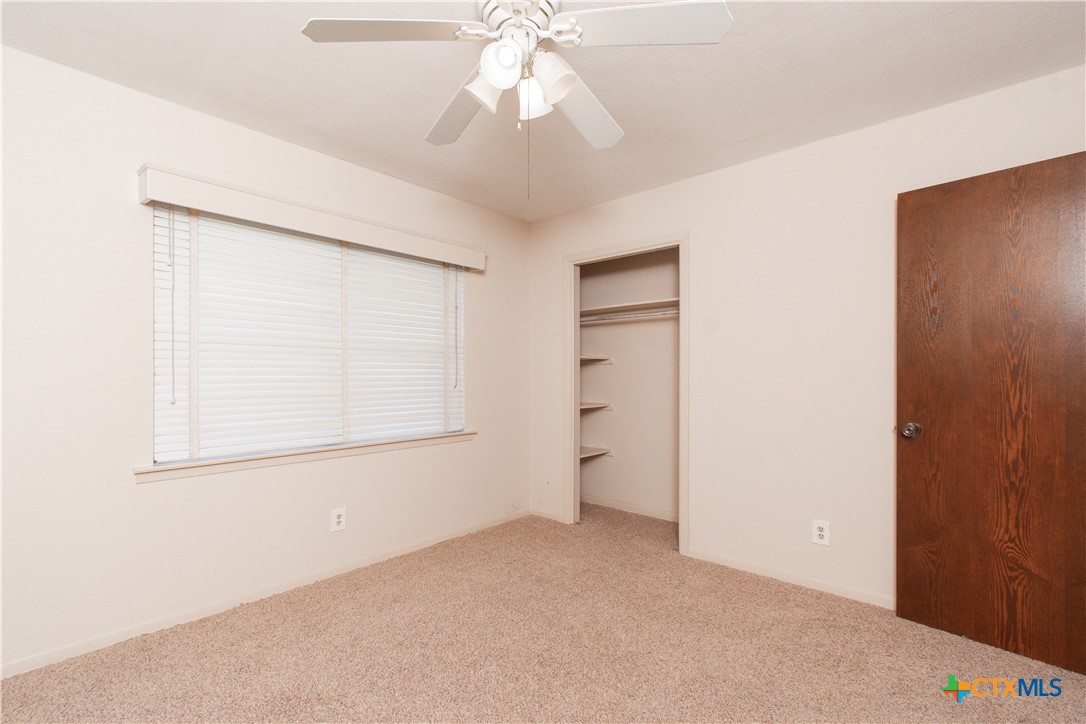 1 Timberline Drive Belton, TX 76513 - Photo 21 of 46 an empty room with a ceiling fan and a window