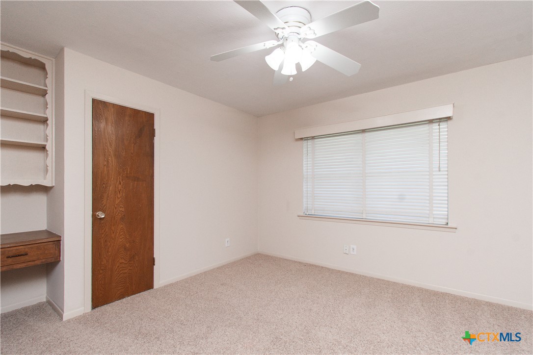1 Timberline Drive Belton, TX 76513 - Photo 22 of 46 an empty room with a ceiling fan and a window
