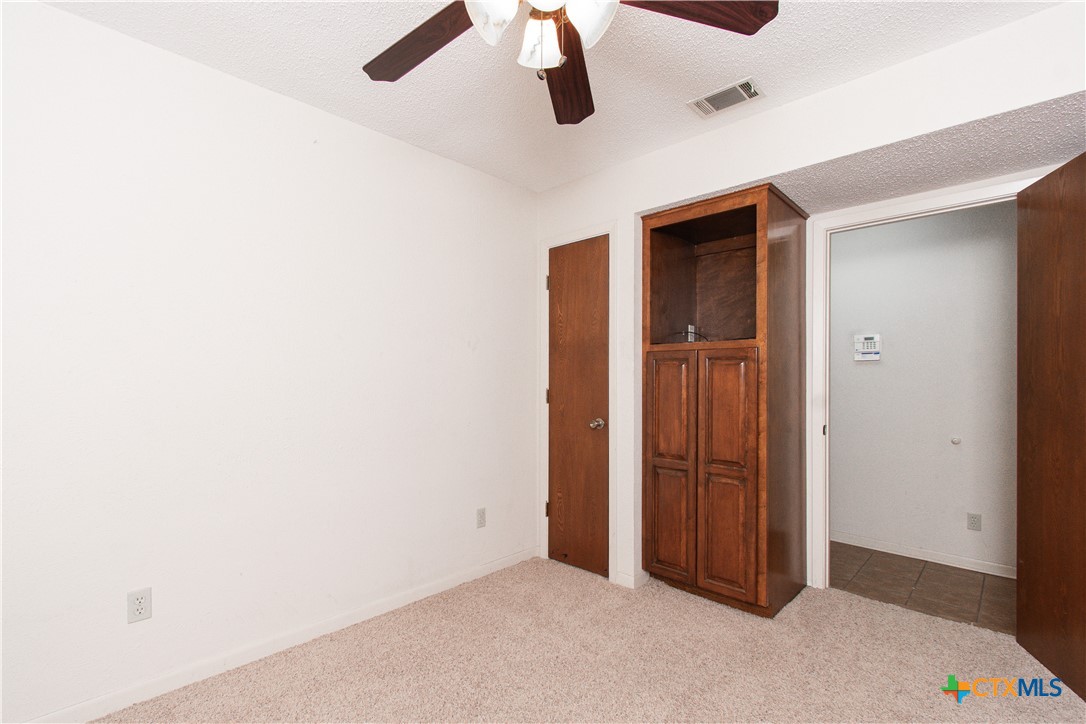 1 Timberline Drive Belton, TX 76513 - Photo 26 of 46 an empty room with a chandelier fan and closet