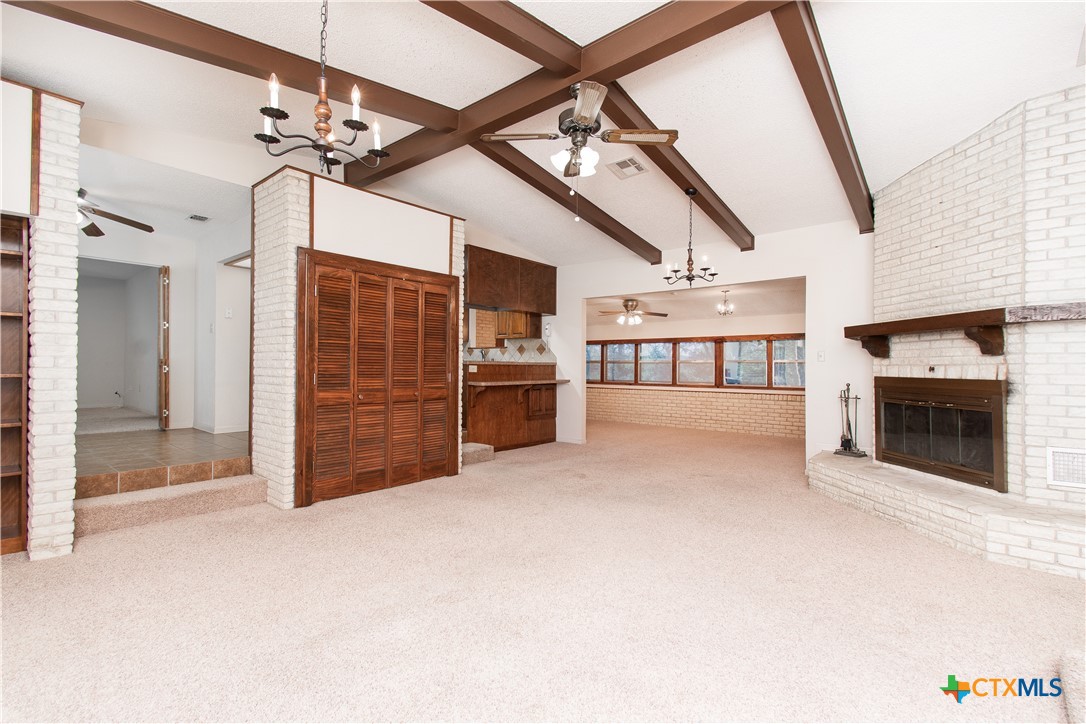 1 Timberline Drive Belton, TX 76513 - Photo 3 of 46 a view of an empty room with a fireplace and chandelier