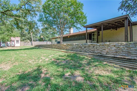 a view of a backyard with large trees
