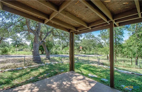 a view of a backyard with large trees