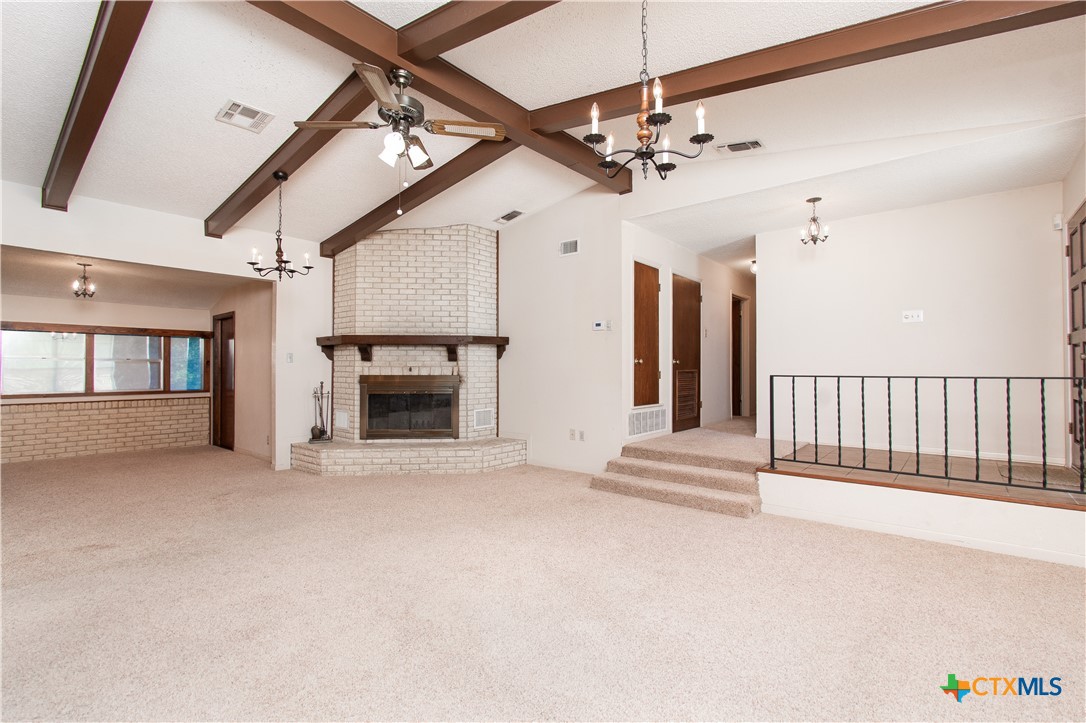 1 Timberline Drive Belton, TX 76513 - Photo 4 of 46 a view of a livingroom with a fireplace a ceiling fan and windows
