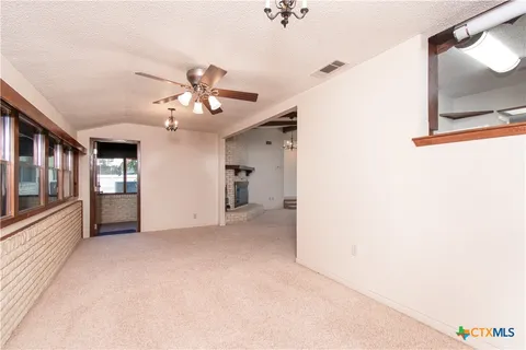 a view of a kitchen with a sink and a chandelier fan