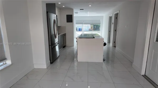 a kitchen with refrigerator and cabinets